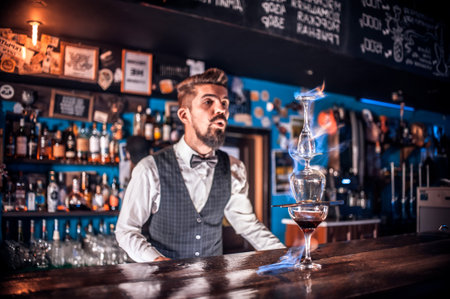 Barman mixes a cocktail at the barの写真素材