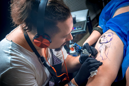 Tattoo artist making tattoo art in a workshop studioの写真素材