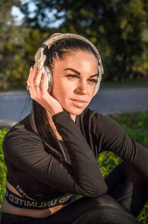 Cute sporty girl enjoying music with headphonesの写真素材