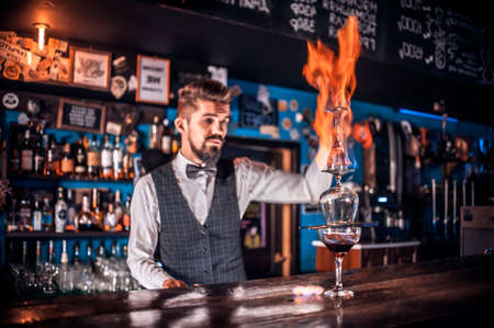 Barman concocts a cocktail behind the barの写真素材
