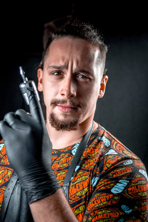 Tattoo specialist looking at the camera in tattoo studioの写真素材