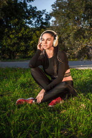 Nice sporty girl and headphones listen music and smileの写真素材