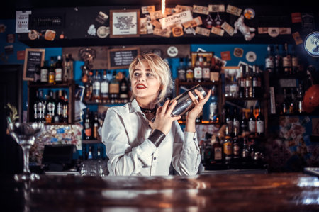 Girl bartender creates a cocktail at the barの写真素材