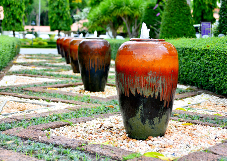 row of jar fountain in the gardenの写真素材