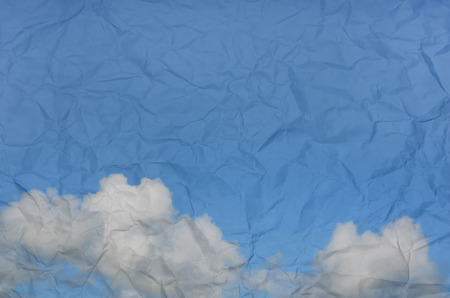 white cloud and blue sky on crumpled paper grungeの写真素材