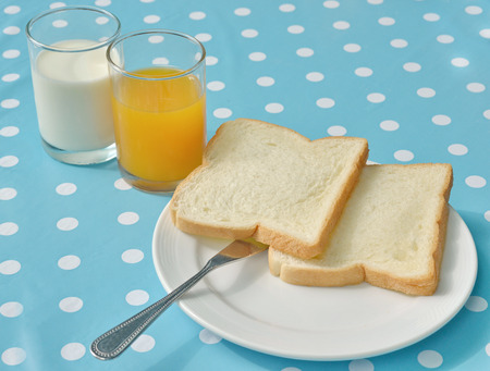 breakfast bread milk orange juice on the tableの写真素材