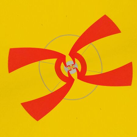 intricate circular variations through design all based on single red arrow on vibrant yellow backdropの写真素材