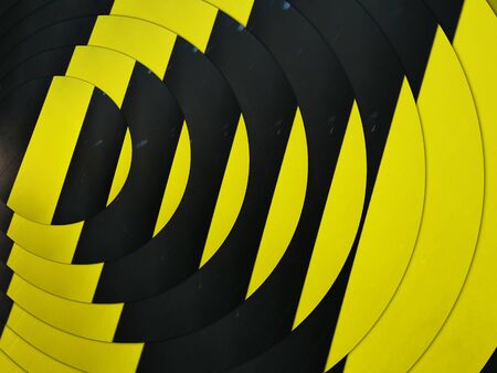 intricate concentric pattern through design all based on multiple black diagonal on a vibrant yellow...