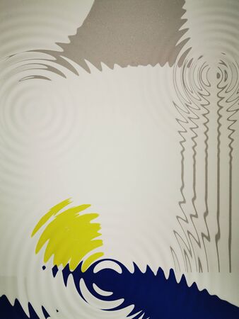 ripple effects from bright blue foundation with a single vivid yellow ball on a white background...