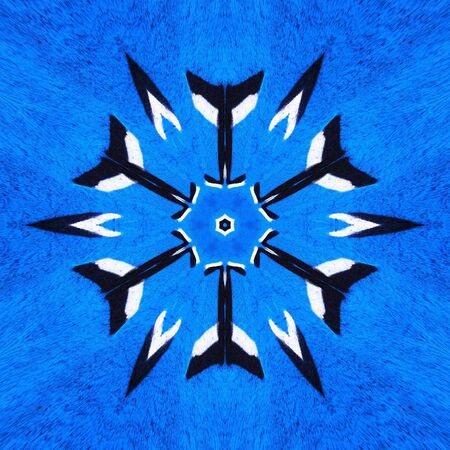 floral view of two pronged fork design in black and white against a vivid royal blue a textured wall transformed into intricate patterns by reflection and twistingの写真素材