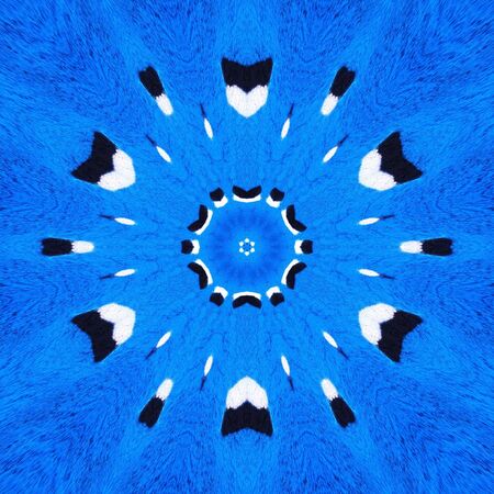 two pronged fork design in black and white against a vivid royal blue a textured wall transformed into intricate patterns by reflection and twistingの写真素材