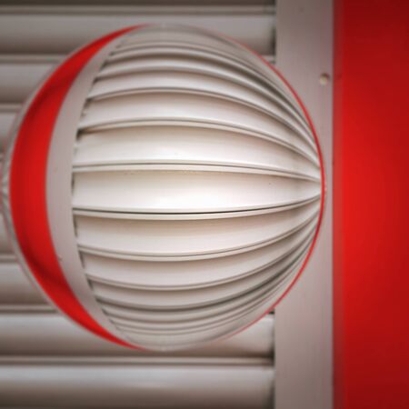 vivid red and bright white colored shutter with glass globe transformed into patterns and designs