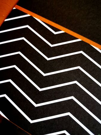 black and white line doodles with single orange flash making intricate patterns and designsの写真素材