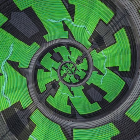 spiral effect of huge capital letter N  in green paint on shutter doors on a dark background into shapes patterns and intricate designsの写真素材