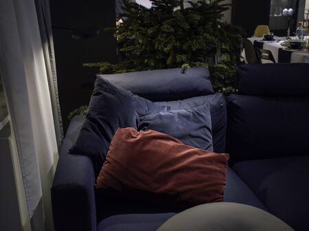 Pillows on the sofa under the Christmas tree. Waiting for gala dinner