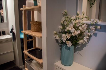 The interior of the bathroom. A vase of flowers is in the bathroom.の写真素材