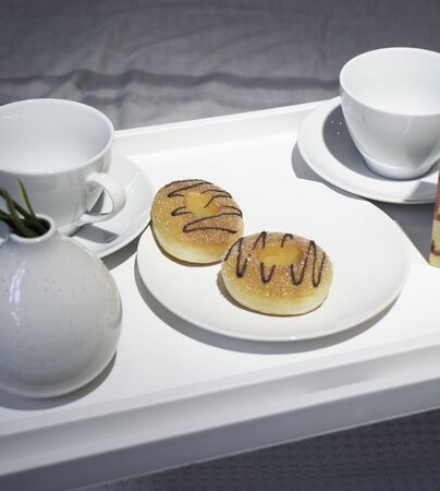 Breakfast in bed. Donuts for breakfast. Breakfast in bed at weekendの写真素材