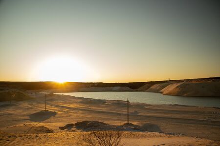Footprints in the sand in the desert. The road to the oasis. Sunset.の写真素材