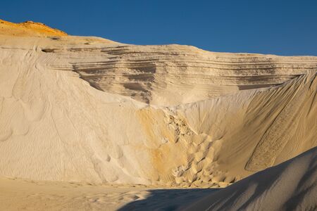 Embossed sand mountains of white sands. Desert landscape.の写真素材