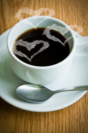 Coffee cup with heart-shaped  smokeの写真素材