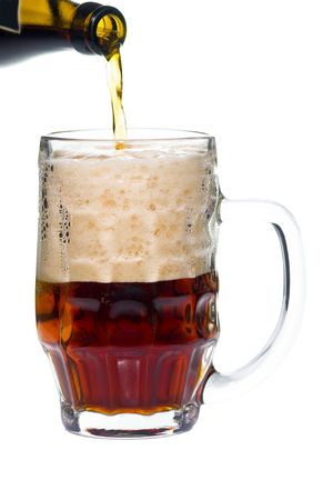 Dark beer in glass with white foam and bottle isolatedの写真素材