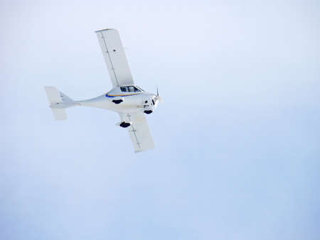 Flight Design CTSW. Zoom photo of small propeller airplane landing to small airport.