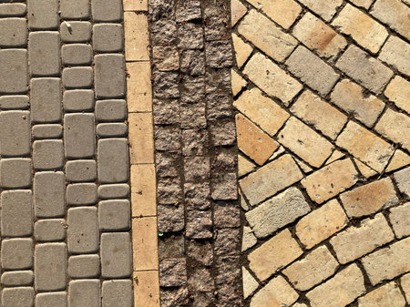 Yellow stone tiles masonry closeup background. the texture of yellow antique paving stones. Old...