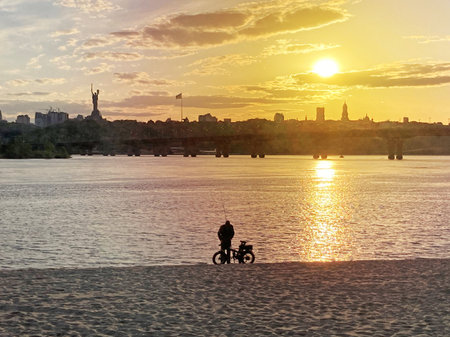 Historical sights of Ukraine. Beautiful scenic view of Kyiv. Sunset over the Dnieper River in Kiev. View of the river with waves. Dramatic colorful sunset over Dnipro river in Kiev, Ukraine, travelの写真素材