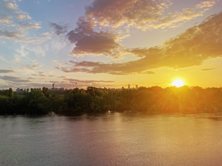 Historical sights of Ukraine. Beautiful scenic view of Kyiv. Sunset over the Dnieper River in Kiev....