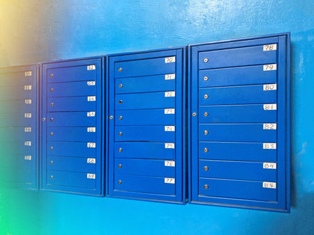 Backdrop of rows of numbered mailbox in modern residential apartments with flare background. Background of blue Mailboxes in an apartment residential build. correspondence concept. Copy text spaceの写真素材