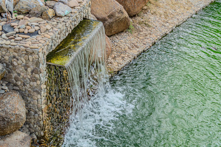 Water flowing from a waterfall in the park. The concept of clean water.の写真素材