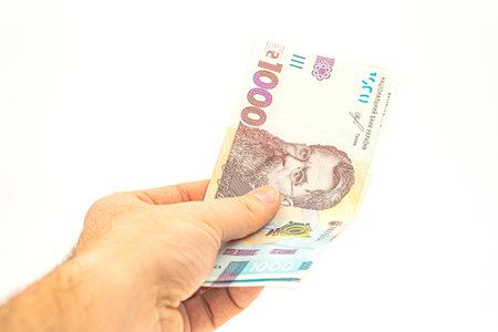 1000 hryvnia in hand isolated on a white background. Banknote with the maximum Ukrainian...