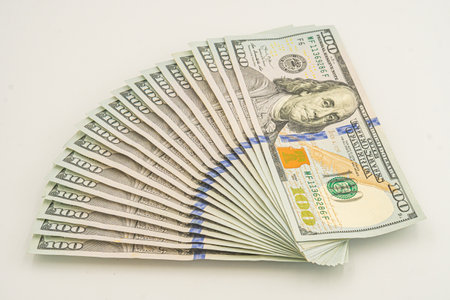 Fan of one hundred dollar bills isolated on white background. American money fanned out. Concept of...