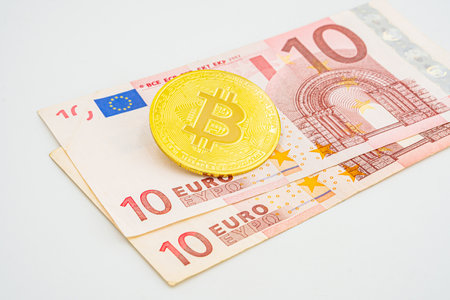 bitcoin to euro, crypto concept. Bitcoin in Europe. photo of golden bitcoins new virtual currency with traditional dollars and euro as a background.の写真素材