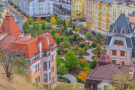 Park in the fall amidst old European architecture. Multicolored trees in the park top view of multicolored houses. Kyiv, Ukraine, 10-18-2023のeditorial素材