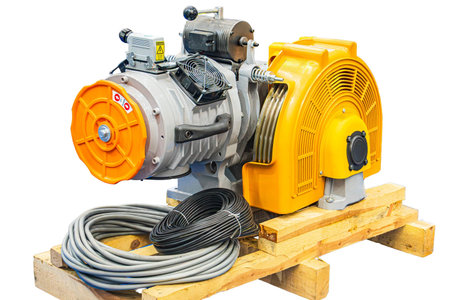 Yellow and gray industrial equipment, possibly a generator or motor assembly, on wooden pallet...
