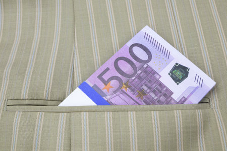 A pack of 500 euro banknotes in the pocket of a striped jacket. High quality photoの写真素材