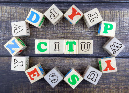 Word - City - in colorful alphabet letters on wooden cubes surrounded by a frame of additional random blocks over a textured textile background. Flat lay, top viewの写真素材