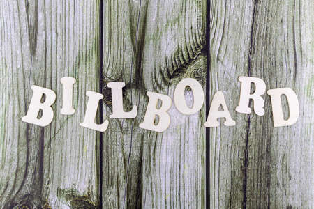Billboard - concept design template on old stained wood background with woodgrain texture and copyspace above and belowの写真素材