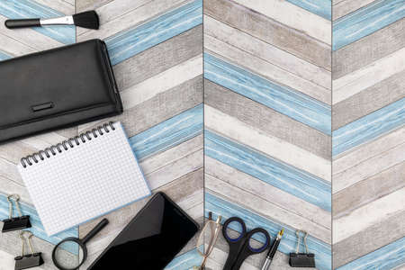 Artistic office or business background with copyspace on a zig-zag wood pattern with mobile phone,...