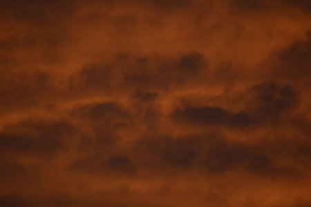 Vertical formation of mammatus-style clouds glowing orange creating a powerful weather texture.