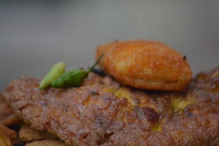 Extreme close up of crispy fried snack surface showing texture and seasoning with shallow depth of...