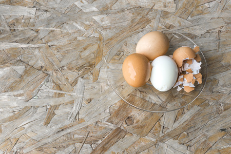top view of eggs in bowl, egg on the table, copy space for text.
