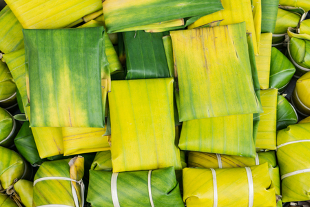 Banana leaf use Thai style dessert made from Steamed Flour with Filling inside wrapped with banana leaf.の写真素材