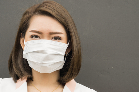 Asian woman wear protective face mask in pollution city with coughing., copy space for textの写真素材