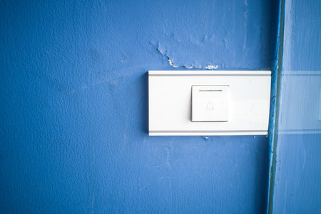 bell switch button on the blue wall.の写真素材