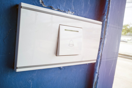 bell switch button on the blue wall.