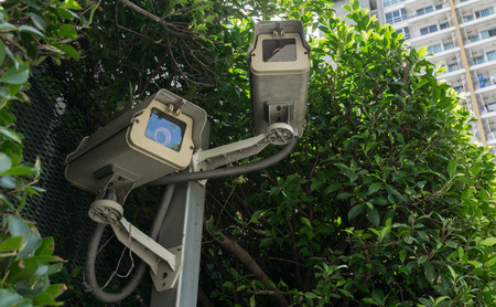 CCTV camera security the green park., CCTV is attached to the public park. To monitor the safety and enforce the rules within the park.の写真素材