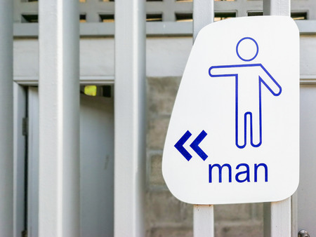 Male toilet sign on wooden wall.の写真素材