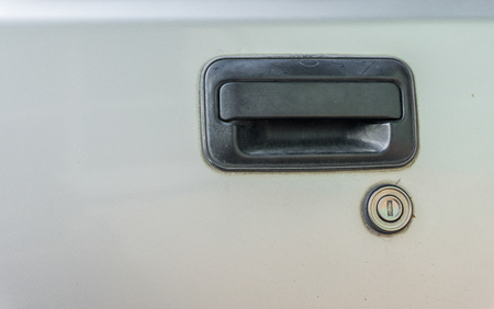 Door black handle of old silver car., backgroundの写真素材